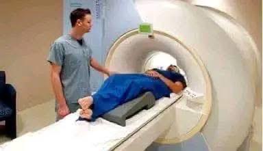 Healthcare technician operating advanced medical scanner